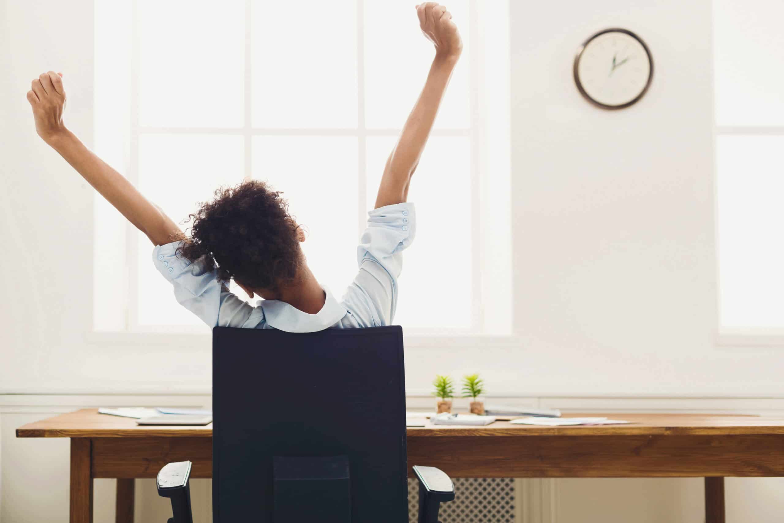 Young african-american business woman rest, stretching on office chair, copy space, back view